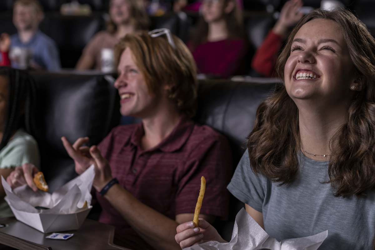 People enjoying a movie while eating snacks