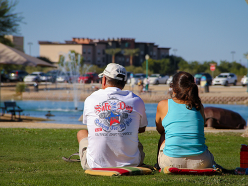 Couple sitting at the Surprise Community Park shoreside